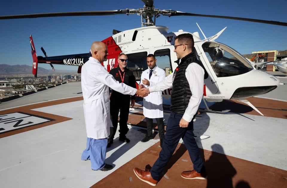 Dr. Toby Enniss, University of Utah Health Department of Surgery’s trauma medical director, shakes hands with Dr. Ryan Metcalf, University of Utah Health section chief of transfusion medicine and ARUP Laboratories Department of Pathology inpatient chief value officer, during a press conference to announce ARUP Blood Services’ new Whole Blood Titan program for Type O blood donors at the University of Utah Hospital helipad in Salt Lake City on Wednesday, Oct. 18, 2023. This will allow the donor’s whole blood to be used instead of the current practice of breaking it down into three component parts. Behind them are Dr. Eric Swanson, University of Utah Health AirMed medical director, and Dr. Waseem Anani, ARUP Blood Services medical director. | Kristin Murphy, Deseret News