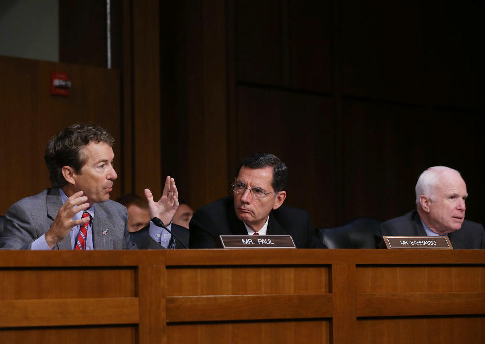 WASHINGTON, DC - SEPTEMBER 04:  U.S. Sen. Rand Paul (R-KY) (L) speaks while U.S. Sen. John Barrasso (R-WY) (C) and John McCain (R-AZ) (R) listen before the Senate Foreign Relations Committee vote on a resolution on Syria on Capitol Hill September 4, 2013 in Washington, DC. The Senate Foreign Relations Committee voted to authorize U.S. President Barack Obama to use limited force against Syria after adopting amendments from McCain (R-NV).  (Photo by Mark Wilson/Getty Images)