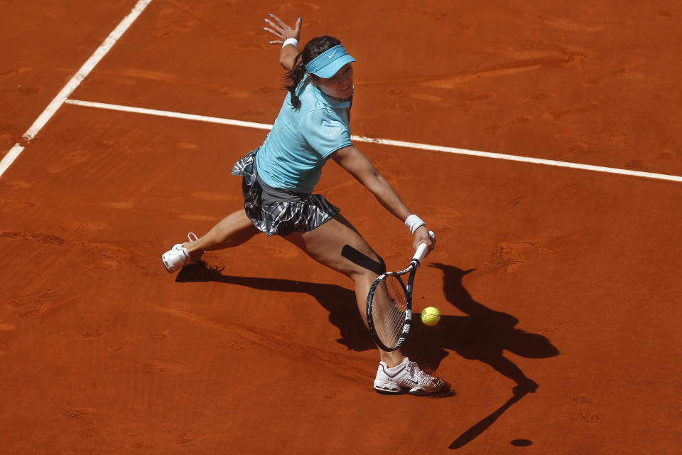 Li Na from China returns the ball during a Madrid Open tennis tournament match against Jie Zheng from China, in Madrid, Spain, Tuesday, May 6, 2014. (AP Photo/Andres Kudacki)