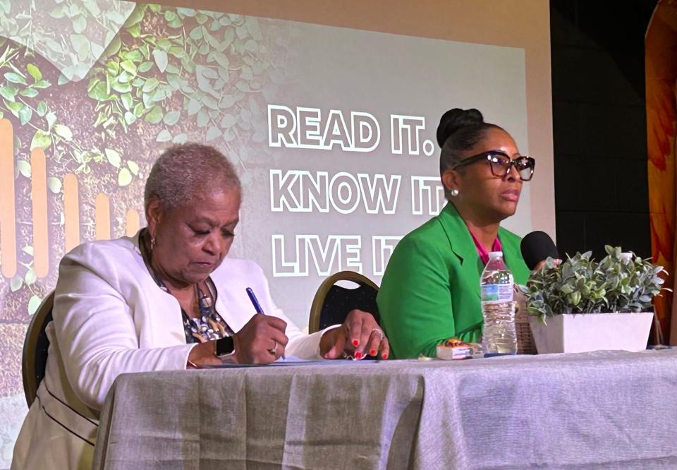 Savannah-Chatham School Board District 3 Representative Cornelia Hall jots notes as challenger Tanet Taharka Myers addresses the school board election forum audience on Sunday May 19, 2024 at Front Porch Improv.