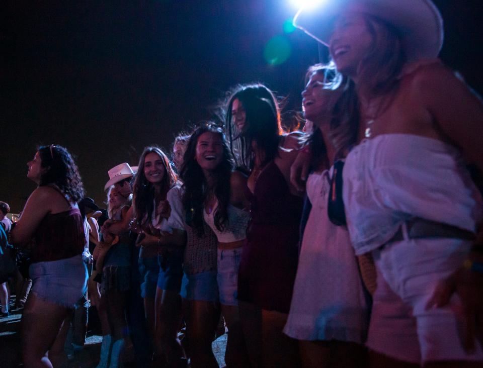 Festivalgoers link arms and dance together as Eric Church opens with "Hallelujah" by Leonard Cohen to start his headlining set on the Mane Stage during Stagecoach country music festival in Indio, Calif., Friday, April 26, 2024.