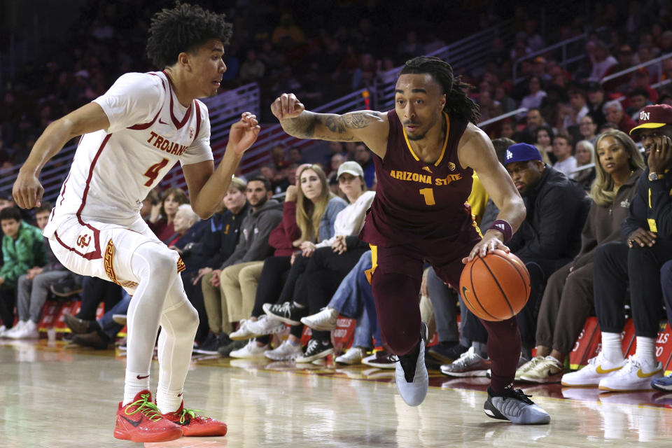 Arizona State guard Frankie Collins (1) drives against Southern California guard Oziyah Sellers (4) during the second half of an NCAA college basketball game Thursday, March 7, 2024, in Los Angeles. Southern California won 81-73. (AP Photo/Raul Romero Jr.)