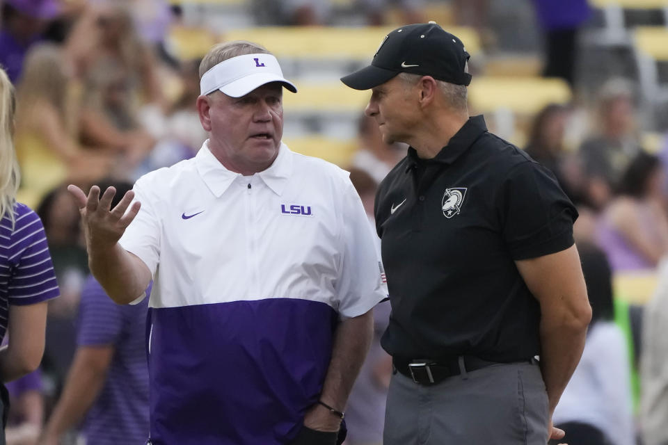 LSU head coach Brian Kelly, left, talks to Army head coach Jeff Monken before an NCAA college football game in Baton Rouge, La., Saturday, Oct. 21, 2023. (AP Photo/Gerald Herbert)