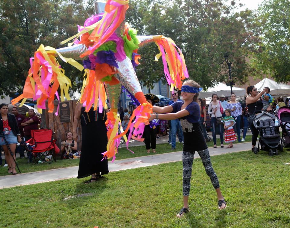 Emily Melton, 10, from El Paso, tries to break open a piñata at the Diez y Seis de Septiembre Fiesta on Sunday, Sept. 15, 2019, at the Mesilla Plaza.
