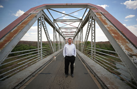 Suidlander movement spokesman Simon Roche stands on a bridge over the Orange River near Van der Kloof, South Africa, October 29, 2018. REUTERS/Mike Hutchings/File Photo