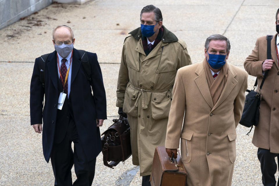 From left, David Schoen, Bruce Castor and Michael van der Veen, lawyers for former President Donald Trump, arrive at the Capitol on the third day of the second impeachment trial of Trump in the Senate, Thursday, Feb. 11, 2021, in Washington. (AP Photo/Jose Luis Magana)