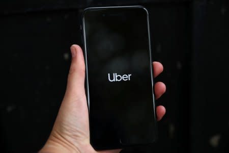 Uber's logo is displayed on a mobile phone in London, Britain, September 14, 2018. REUTERS/Hannah Mckay