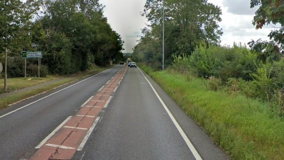 Single-carriageway road with right turn to Potterspury visible