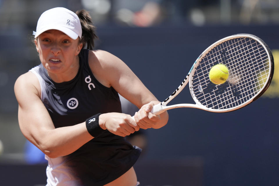 FILE - Iga Swiatek returns the ball to Lesia Tsurenko at the Italian Open tennis tournament, in Rome, Sunday, May 14, 2023. Play begins at the French Open on Sunday, May 28, 2023. (AP Photo/Andrew Medichini, File)