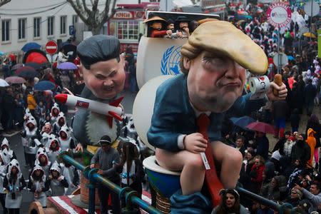 A carnival chariot is seen with figures of U.S. President Donald Trump and North Korean leader Kim Jong Un during a parade in Torres Vedras, Portugal February 11, 2018. REUTERS/Pedro Nunes