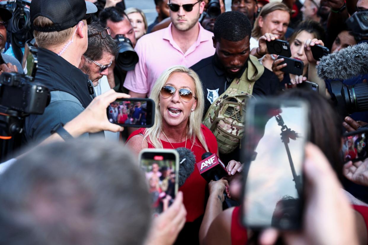 Representative Marjorie Taylor Greene (R-GA) speaks to the media near the entrance of the Fulton County Jail (REUTERS)