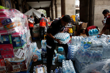 Volunteers work at a collection center in Mexico City, organizing donations to be delivered to people affected by an earthquake that struck on the southern coast of Mexico late on Thursday, September 9, 2017. REUTERS/Ginnette Riquelme
