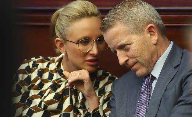 Book confers with Florida state Rep. Paul Renner (R) during a debate on property insurance on May 24.