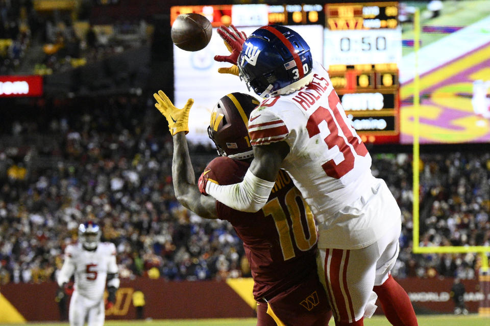 New York Giants cornerback Darnay Holmes (30) defends Washington Commanders wide receiver Curtis Samuel (10) on fourth down to seal a 20-12 victory, Sunday, Dec. 18, 2022, in Landover, Md. (AP Photo/Nick Wass)