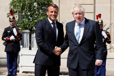 French President Emmanuel Macron welcomes British Prime Minister Boris Johnson before a meeting on Brexit at the Elysee Palace in Paris