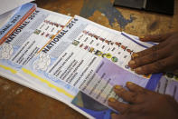 Ballots printed with names and photos of election candidates and their political parties are seen at a polling station in the township of Nyanga on the outskirts of Cape Town, South Africa, Wednesday, May 7, 2014. (AP Photo/Schalk van Zuydam)