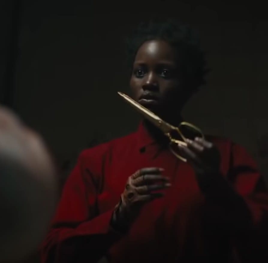 Lupita Nyong'o holds some scissors in"Us"