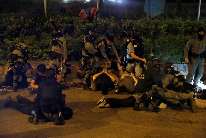 Detained protesters lay on the floor after they tried to leave Hong Kong Polytechnic University (PolyU) campus, in Hong Kong