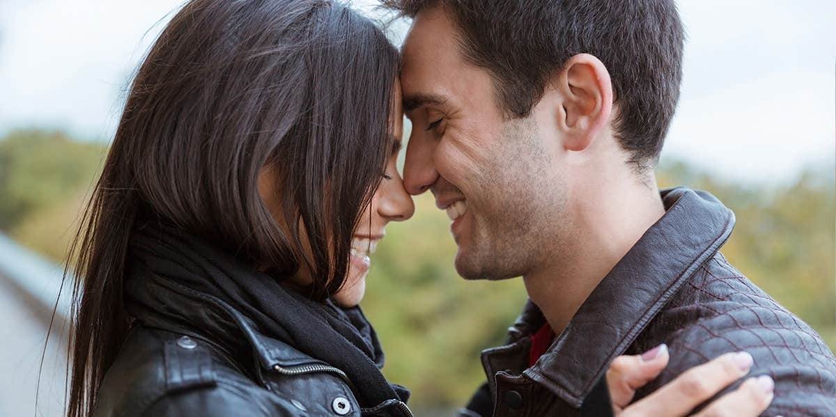 woman and man embracing with foreheads touching