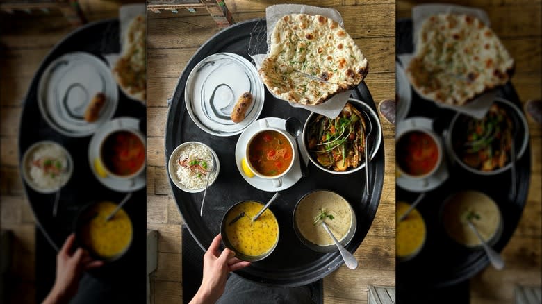 Indian food spread black plate