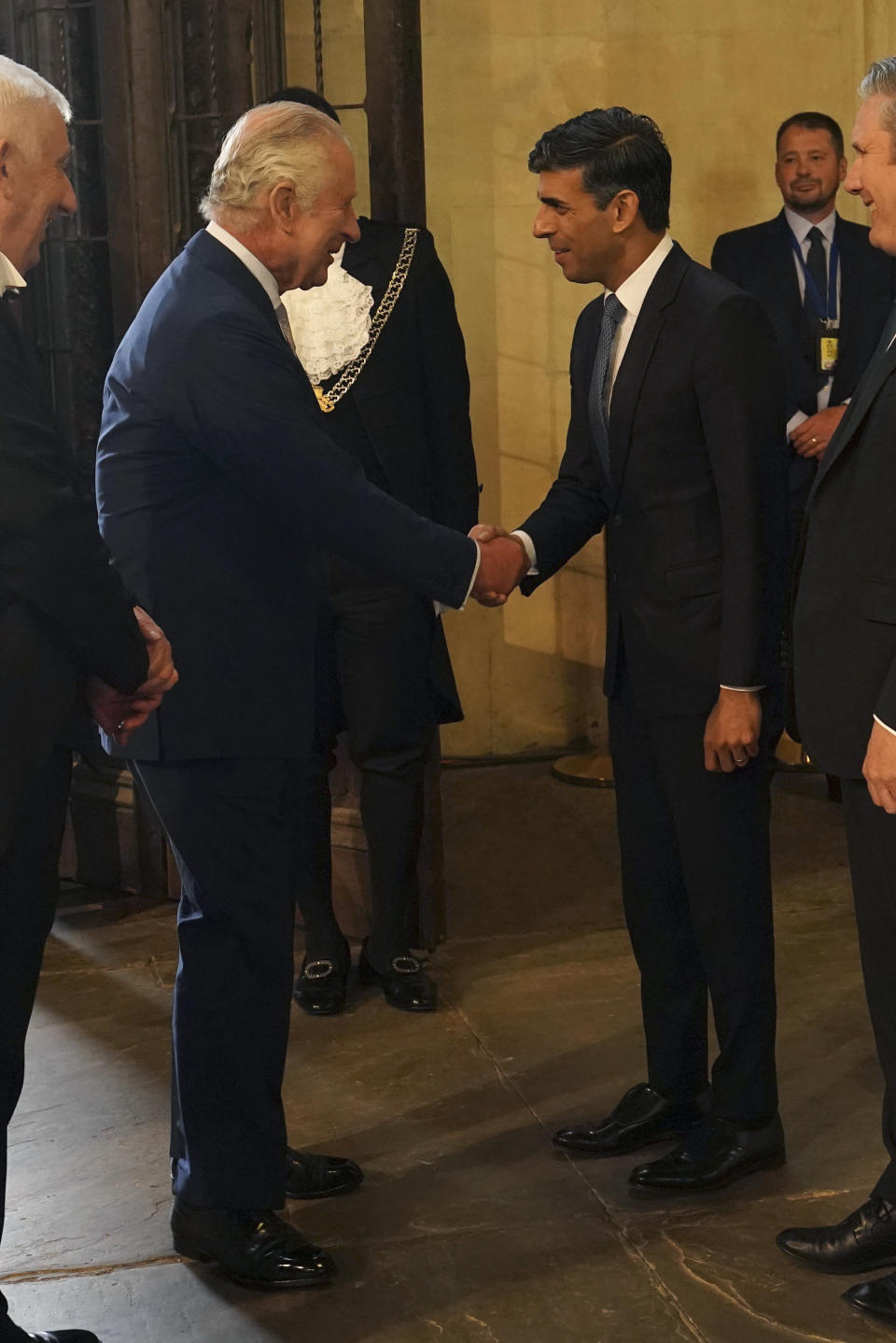 Britain's King Charles III, left, shakes hands with Prime Minister Rishi Sunak, during a visit to Westminster Hall at the Palace of Westminster to attend a reception ahead of the coronation, in London, Tuesday May 2, 2023. (Arthur Edwards/Pool Photo via AP)