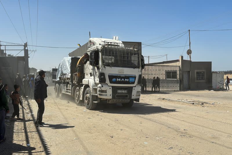 A truck carrying aid enters Gaza via Kerem Shalom crossing, amid the ongoing conflict between Israel and Hamas, in Rafah in the southern Gaza Strip