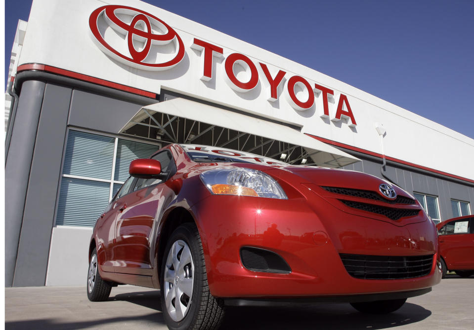 FILE - in this Oct. 22, 2006 file photo, the Toyota sign hangs over a 2007 Yaris sedan on sale on the lot of a Toyota dealership in the southeast Denver suburb of Centennial, Colo. 