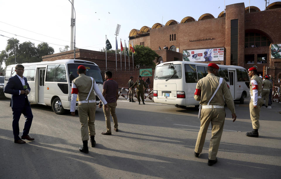 Pakistan's army soldier stand guard while vehicle carrying Sri Lankan cricket team enter into Gaddafi stadium for 1st Twenty20 match against Pakistan, in Lahore, Pakistan, Saturday, Oct. 5, 2019. Pakistan won the toss and elected to field in the first Twenty20 of the three-match series against inexperienced Sri Lanka. (AP Photo/K.M. Chaudary)