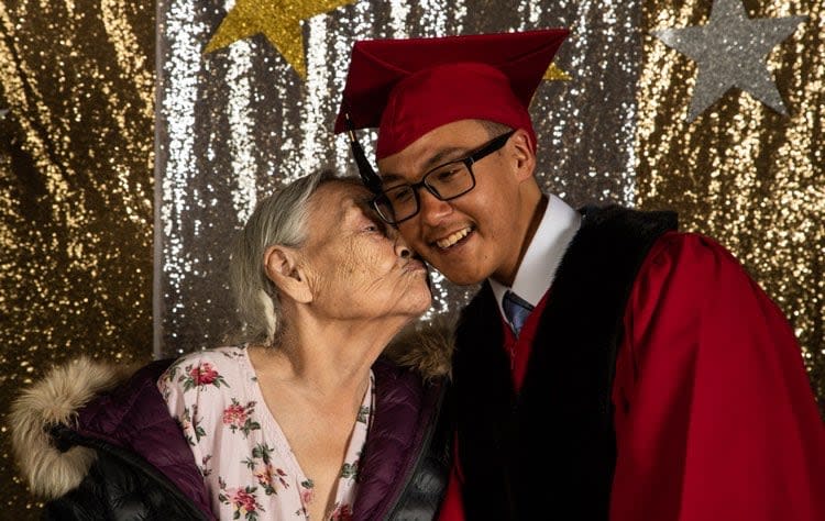 Qapik Attagutsiak and Travis Kines, son of Arctic Bay resident Clare Kines, share a moment during his high school graduation in June 2022. 