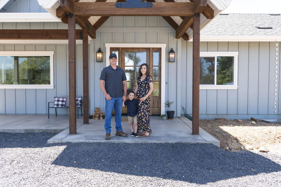 Brian Gobba, left, stands with his wife Morgan and their son in front of the family's new home in Paradise, Calif., Friday, June 14, 2024. The Gobbas found out they were being dropped by their insurance company just before they finished building their home on the east side of Paradise last year. (AP Photo/Nic Coury)