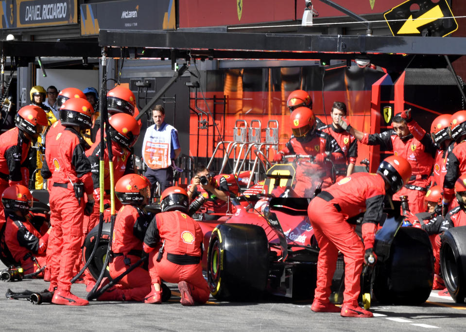 Crew work on the car of Ferrari driver Charles Leclerc of Monaco during the Formula One Grand Prix at the Spa-Francorchamps racetrack in Spa, Belgium, Sunday, Aug. 28, 2022. (AP Photo/Geert Vanden Wijngaert, Pool)