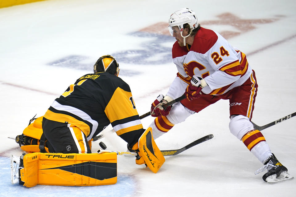 Pittsburgh Penguins goaltender Casey DeSmith (1) blocks a shot by Calgary Flames' Brett Ritchie (24) during the first period of an NHL hockey game in Pittsburgh, Thursday, Oct. 28, 2021. (AP Photo/Gene J. Puskar)