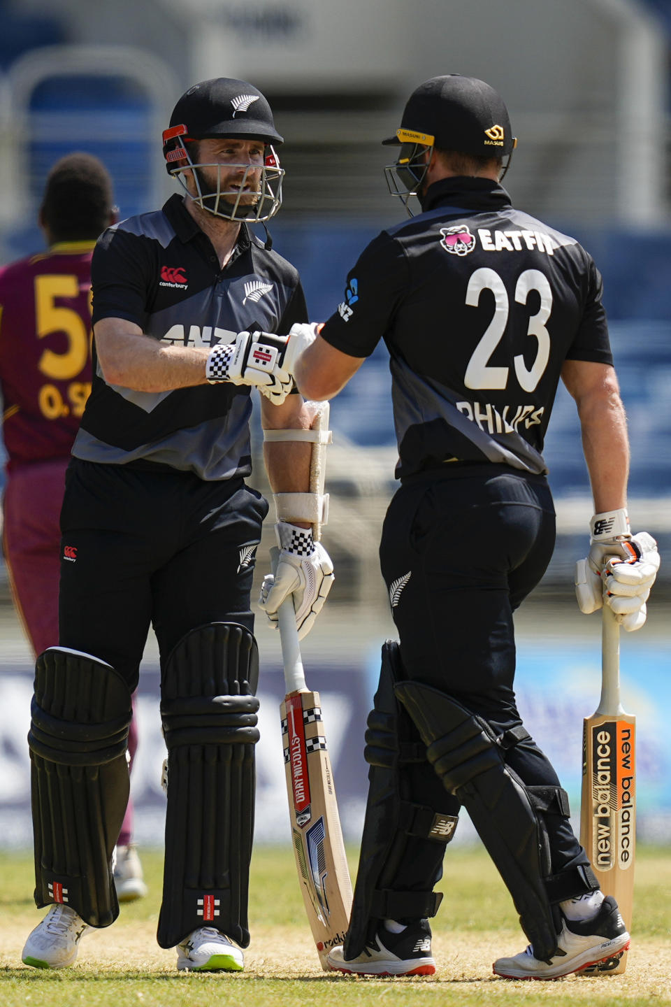 New Zealand's captain Kane Williamson celebrates with Glenn Phillips during their partnership against the West Indies during the third T20 cricket match at Sabina Park in Kingston, Jamaica, Sunday, Aug. 14, 2022. (AP Photo/Ramon Espinosa)