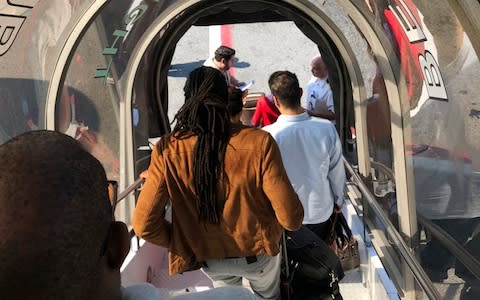 Passengers leave an Emirates airplane at New York's Kennedy Airport amid reports of ill passengers aboard a flight from Dubai  - Credit: AP