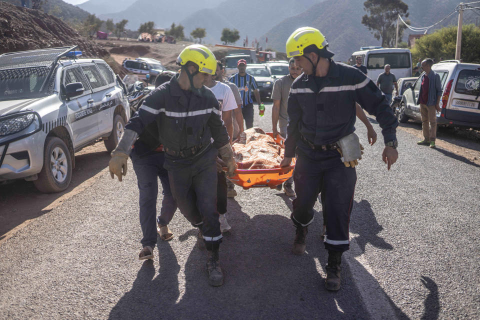 Members of rescue teams carry the body of a victim of an earthquake in Ouargane village, near Marrakech, Morocco, Saturday, Sept. 9, 2023. A rare, powerful earthquake struck Morocco late Friday night, killing more than 1000 people and damaging buildings from villages in the Atlas Mountains to the historic city of Marrakech. (AP Photo/Mosa'ab Elshamy)