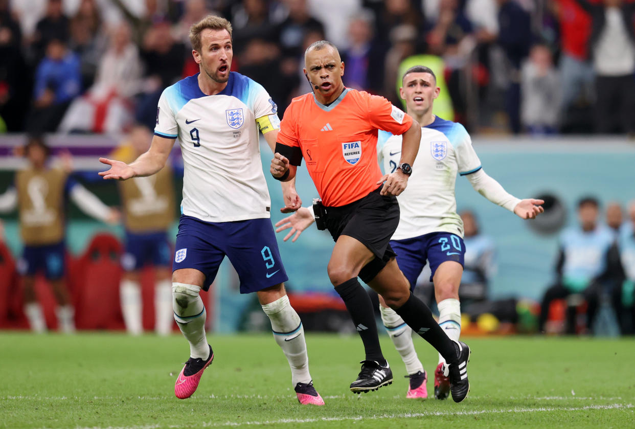 AL KHOR, QATAR - DECEMBER 10: Harry Kane and Phil Foden of England confront referee Wilton Pereira Sampaio during the FIFA World Cup Qatar 2022 quarter final match between England and France at Al Bayt Stadium on December 10, 2022 in Al Khor, Qatar. (Photo by Alex Pantling - The FA/The FA via Getty Images)