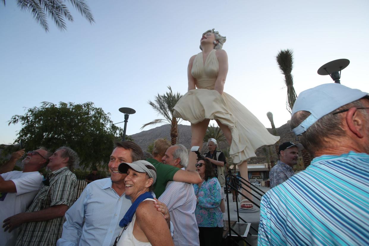 People gather for the unveiling of the "Forever Marilyn" statue in downtown Palm Springs, Calif., on June 20, 2021.