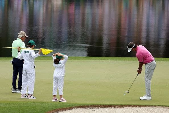 AUGUSTA, GEORGIA - APRIL 10: Bubba Watson of the United States putts on the third green as his family and Ben Crenshaw of the United States watch during the Par Three Contest prior to the 2024 Masters Tournament at Augusta National Golf Club on April 10, 2024 in Augusta, Georgia. (Photo by Jamie Squire/Getty Images) (Photo by Jamie Squire/Getty Images)