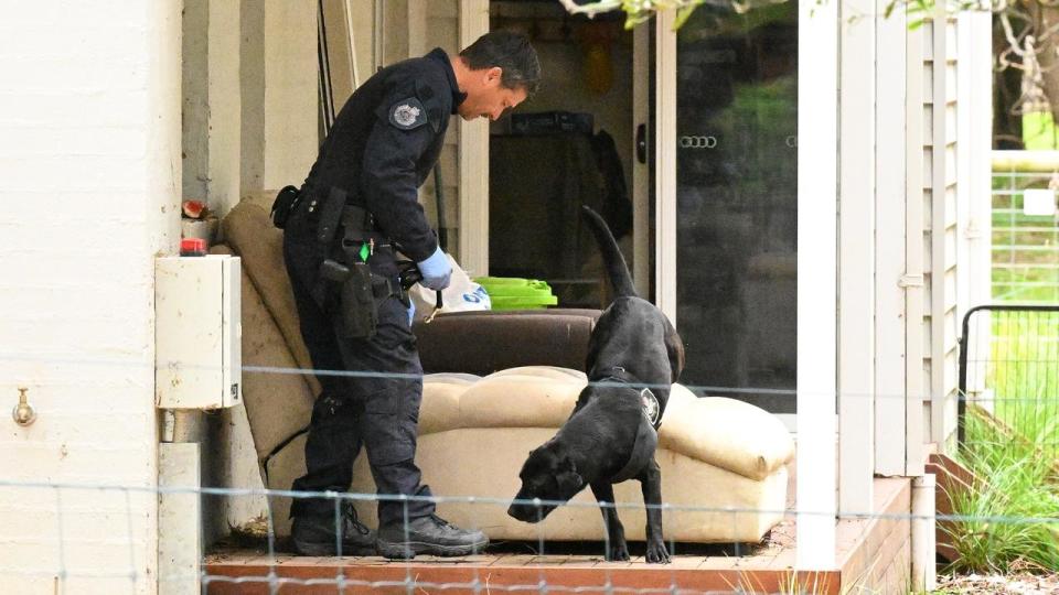 Police officer and dog at Erin Patterson's home (file image)