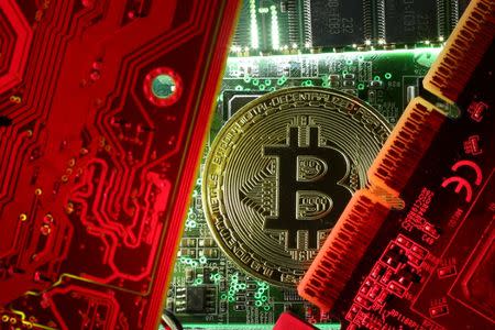 A coin representing the bitcoin cryptocurrency is seen on computer circuit boards in this illustration picture, October 26, 2017. REUTERS/Dado Ruvic/Files