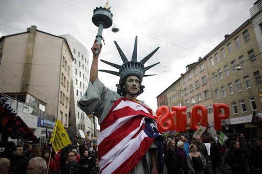 FILE - In this April 23, 2016 file picture a  man walking on stilts and dressed like the Statue of Liberty attends a protest  against the planned Transatlantic Trade and Investment Partnership, TTIP, ahead of the visit of United States President Barack Obama in Hannover, Germany. Germany’s economy minister Sigmar Gabriel  said Sunday Aug. 28, 2016  that free trade talks between the European Union and the United States have failed, citing lack of progress on any of the major chapters of the long-running negotiations.  (AP Photo/Markus Schreiber.file)