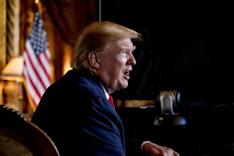 FILE - In this Dec. 24, 2019 photo, President Donald Trump speaks to members of the media following a Christmas Eve video teleconference with members of the military at his Mar-a-Lago estate in Palm Beach, Fla. As a candidate for the White House, Donald Trump repeatedly promised that he would “immediately” replace President Barack Obama’s health care law with a plan of his own that would provide “insurance for everybody.” Back then, Trump made it sound that his plan — “much less expensive and much better” than the Affordable Care Act — was imminent. And he put drug companies on notice that their pricing power no longer would be “politically protected.” Nearly three years after taking office, Americans still are waiting for Trump’s big reveal. (AP Photo/Andrew Harnik)