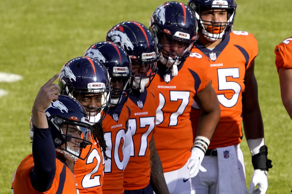 Denver Broncos quarterback Drew Lock, left, motions to his sideline as his teammates look on during the first half of an NFL football game again the Los Angeles Chargers, Sunday, Nov. 1, 2020, in Denver. (AP Photo/Jack Dempsey)