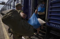 Internally displaced people board a train heading to Dnipro, at the Pokrovsk train station, Donetsk region, eastern Ukraine, Friday, July 8, 2022. (AP Photo/Nariman El-Mofty)