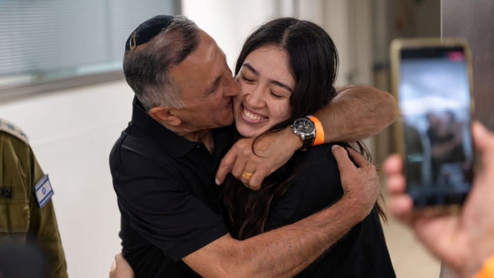 Noa Argamani, a rescued hostage, embraces her father, Yakov Argamani, following her rescue, on June 8, 2024. - Israeli Army/Handout via Reuters