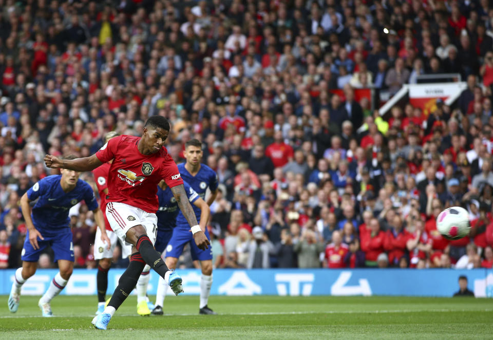 Manchester United's Marcus Rashford shoots a penalty kick to score his sides first goal during the English Premier League soccer match between Manchester United and Chelsea at Old Trafford in Manchester, England, Sunday, Aug. 11, 2019. (AP Photo/Dave Thompson)