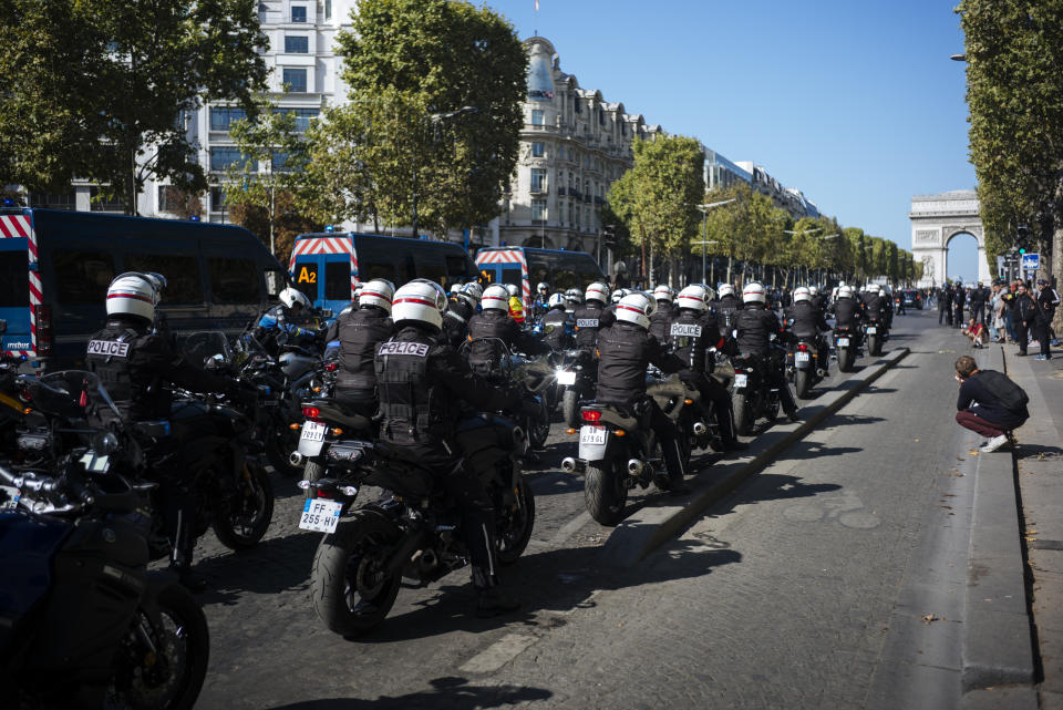 Motorcycle police officers drive along the Champs Elysees during a yellow vests demonstration, in Paris, Saturday, Sept 21. 2019. Paris police have used tear gas to disperse anti-government demonstrators who try to revive the yellow vest movement in protest at perceived economic injustice and French President Emmanuel Macron's government. The French capital was placed under high security as few hundred anti-government protesters started marching in the Paris streets. (AP Photo/Kamil Zihnioglu)