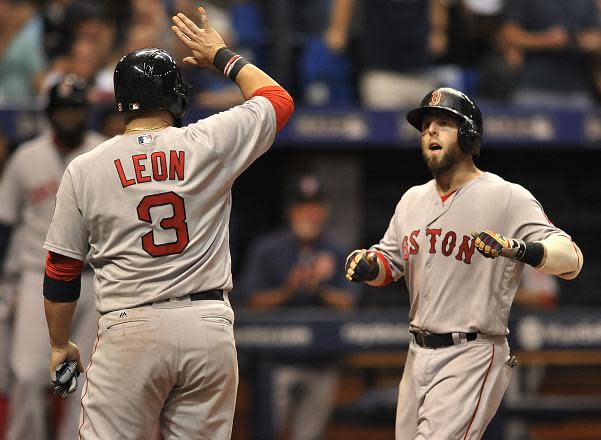 Dustin Pedroia (right) celebrates his go-ahead grand slam in the Red Sox 6-4 win over the Rays. (AP)