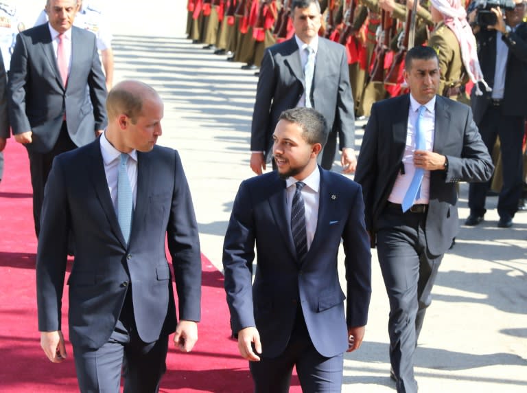 Prince William (L) is greeted at Amman's Marka military airport by Crown Prince Hussein bin Abdullah on June 24, 2018