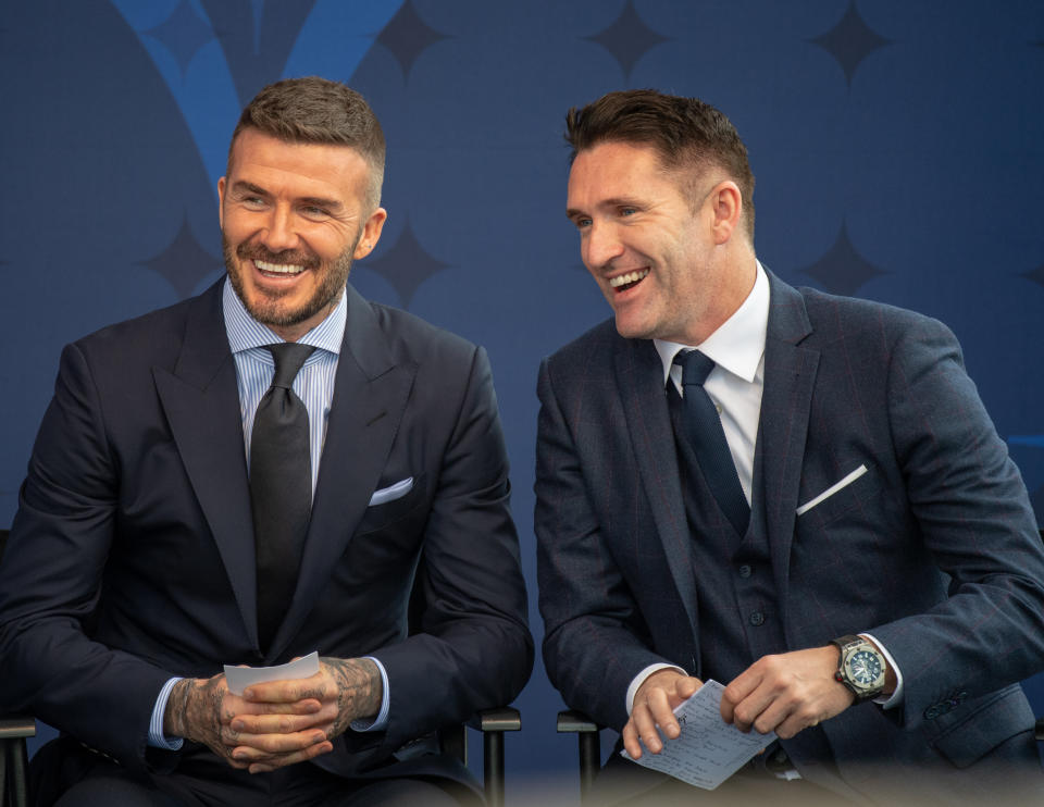 David Beckham laughs with former Galaxy teammate Robbie Keane during his statue unveiling on Saturday in Carson, Calif. (Getty)